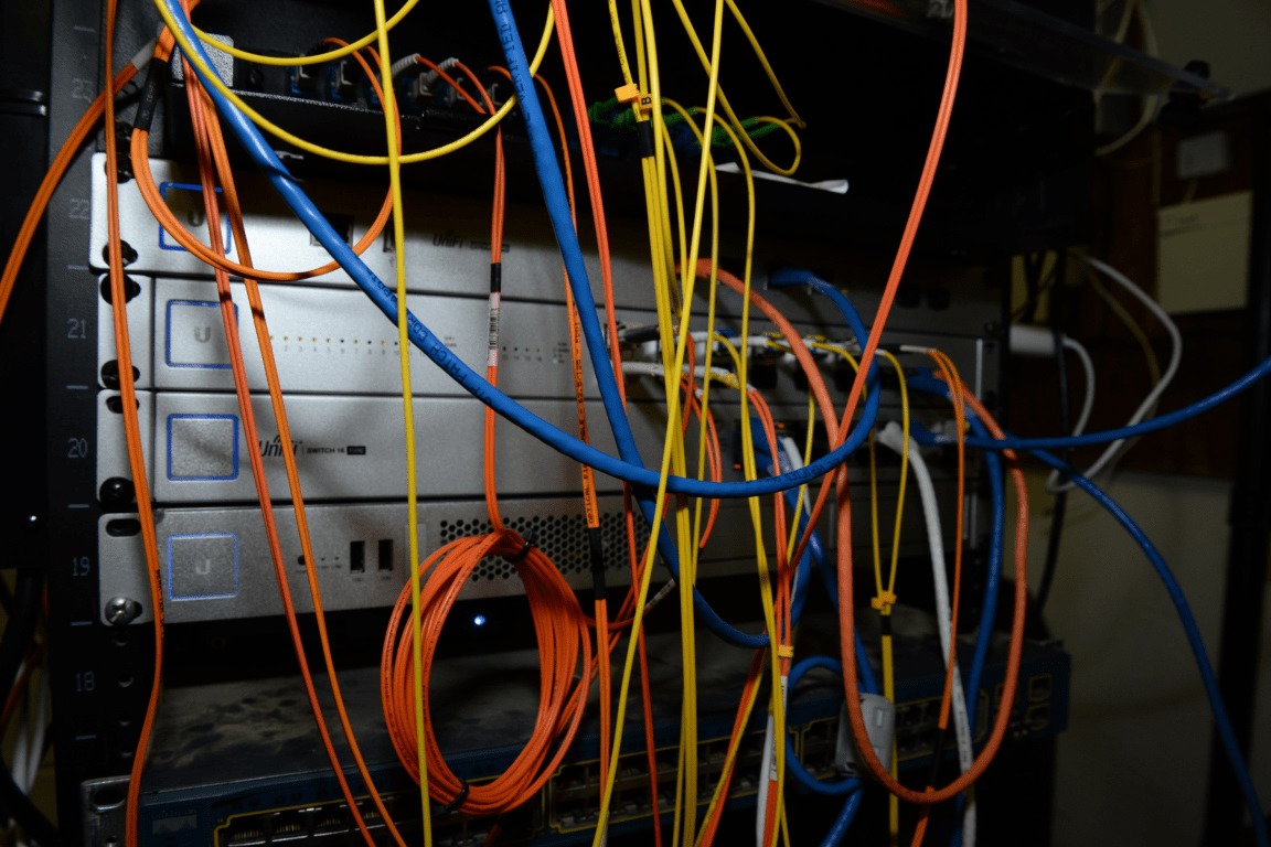 File photo: A server rack with networking equipment and color-coded cables. Illustrative context; not a photograph of the reported event.